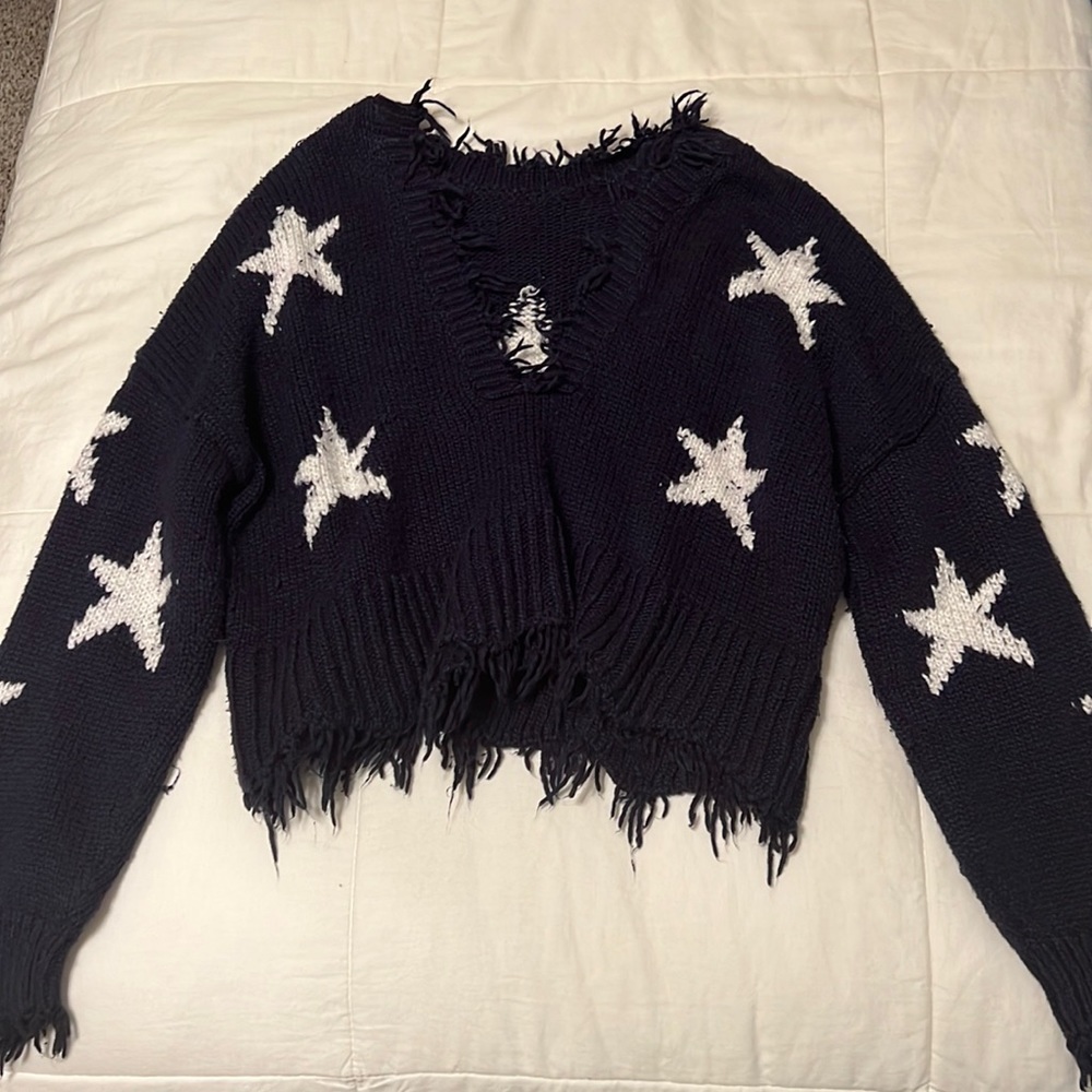 Saks navy off the shoulder sweater with star detailing and distressing